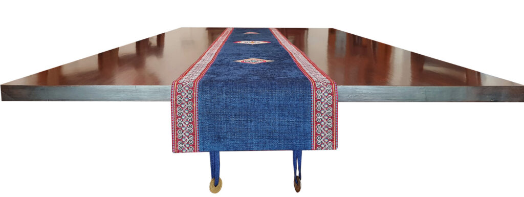 A blue Vietnamese table runner featuring a decorative red and gold border, showcasing traditional design elements