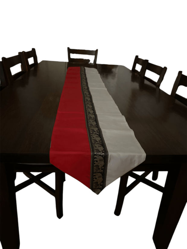 Sophisticated decorative Thai silk table runner with a vibrant red, white, and black design featuring golden elephants at the center, combining traditional Thai artistry with modern elegance.