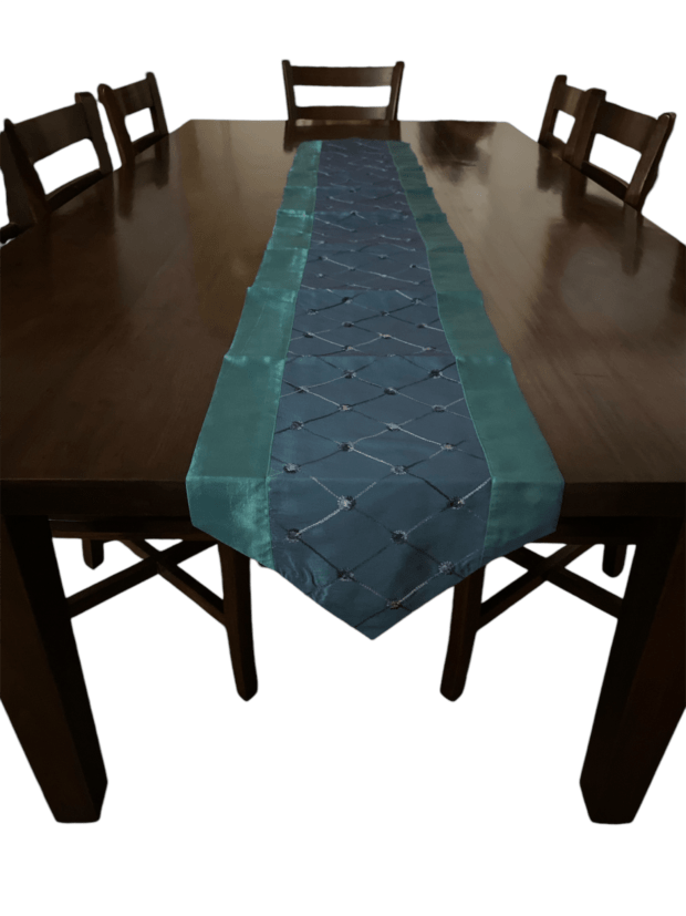 Decorative Thai silk table runner with teal and blue quilted design.